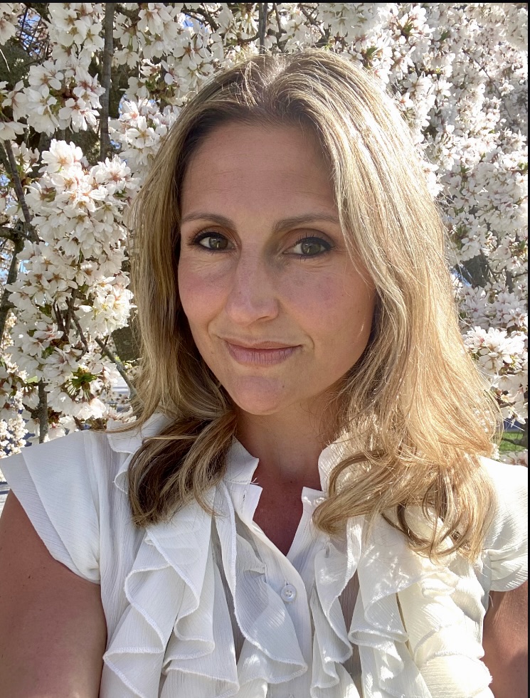 woman in front of flowers