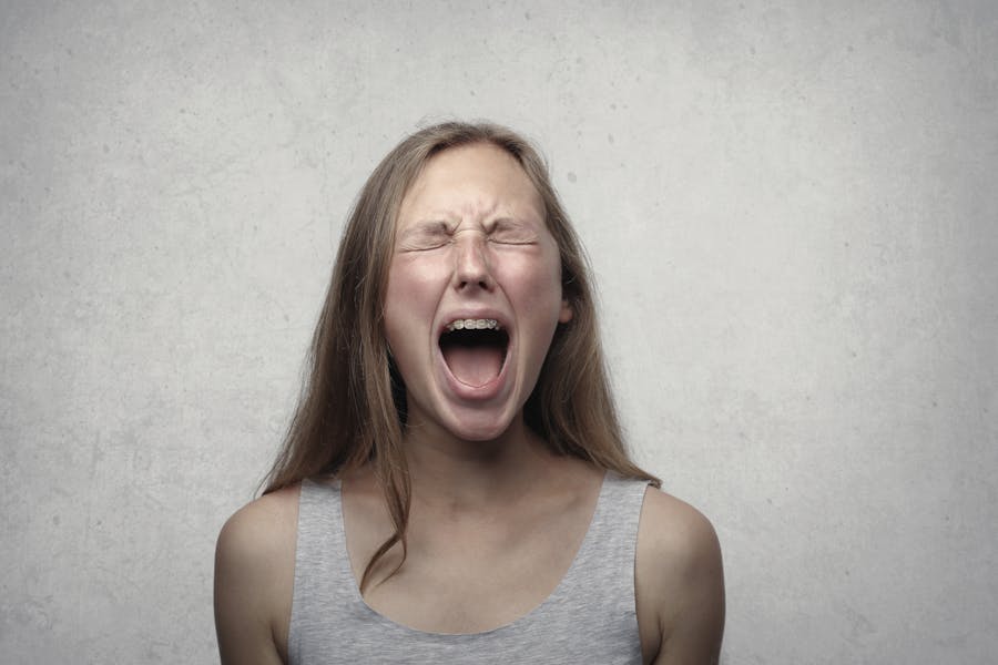 Woman in Gray Tank Top yelling