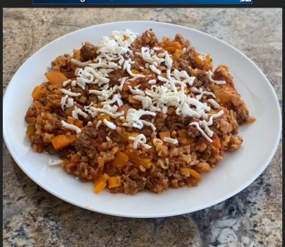 plate with meat, cheese, peppers, onions, and sauce