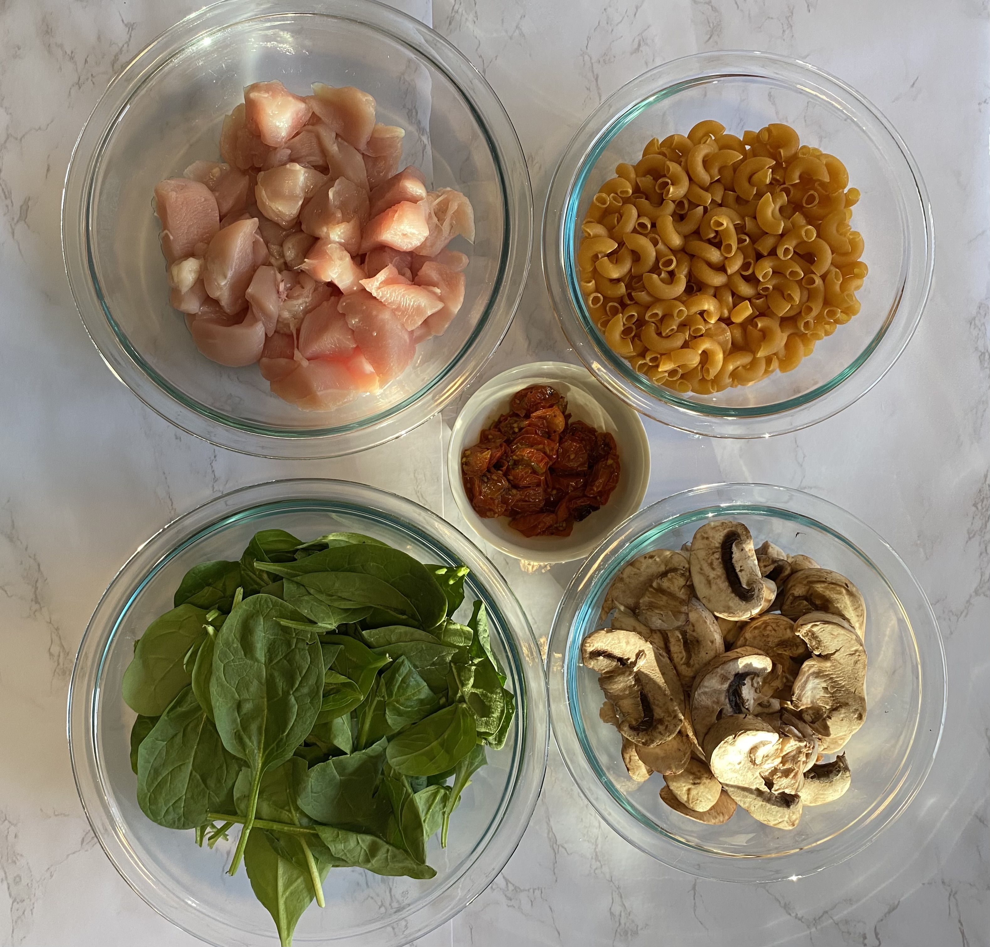 chicken, pasta, sun-dried tomatoes, mushrooms, spinach ingredients for a recipe