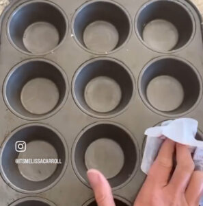 greasing muffin pans with a butter wrapper
